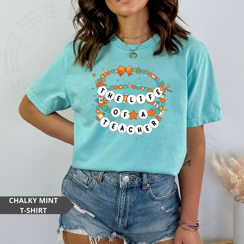 chalky mint Comfort Colors® shirt with colorful beaded bracelet design spelling "The Life Of A Teacher", surrounded by school-themed icons