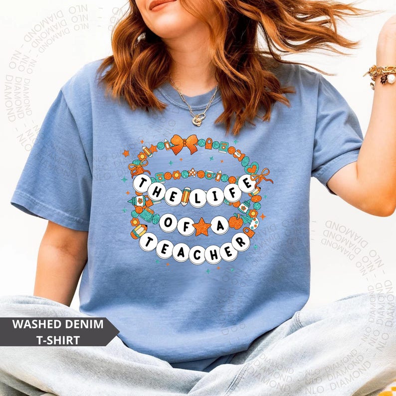 washed denim Comfort Colors® shirt with colorful beaded bracelet design spelling "The Life Of A Teacher", surrounded by school-themed icons
