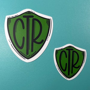May include: Two green shield-shaped stickers with the letters "CTR" in black lettering.
