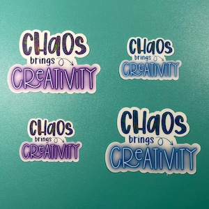 May include: Four stickers with the text "Chaos brings creativity" in a blue and purple glittery font. The stickers are on a turquoise background.