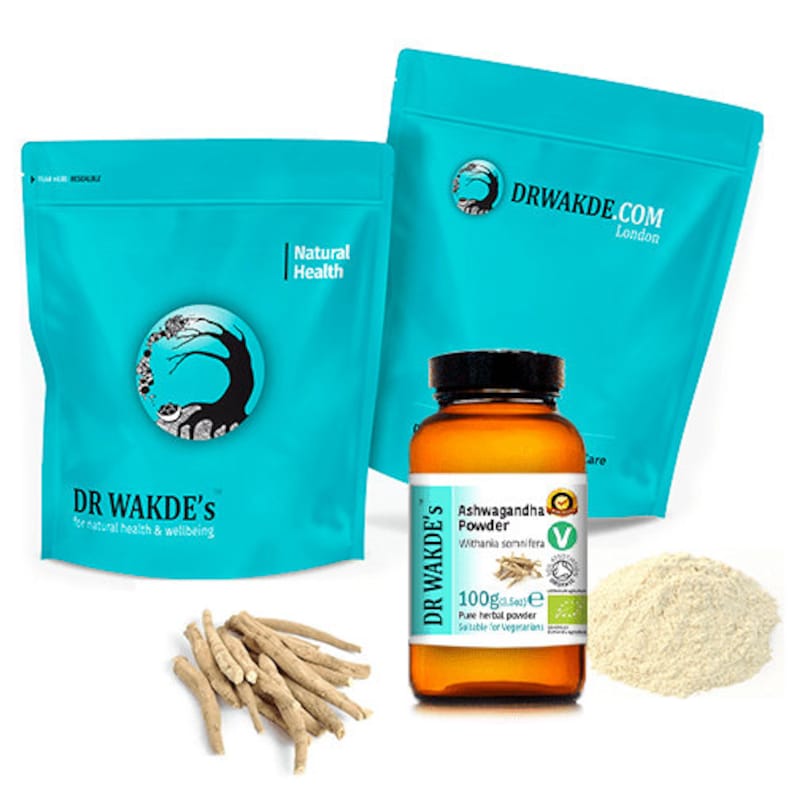 May include: Two blue resealable bags with the text "DR WAKDE'S" and "Natural Health" on them. A brown glass jar with a white label that reads "Ashwagandha Powder" and "DR WAKDE'S". The jar contains a beige powder. A pile of dried roots are in front of the bags.