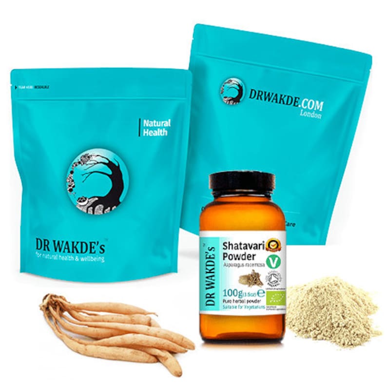 May include: Two blue bags with the text "DR WAKDE'S" and "Natural Health" on them. A brown glass jar with a white label that says "Shatavari Powder" and "100g (3.5oz)". The jar is next to a pile of light brown powder.
