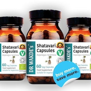 May include: Three brown glass bottles with white labels containing Shatavari Capsules, a food supplement made with Asparagus racemosa. The labels feature a green leaf and a green circle with the text "Soil Association Organic". The bottles are arranged in a row with a blue sticker on the front of the middle bottle that says "buy more. save more."