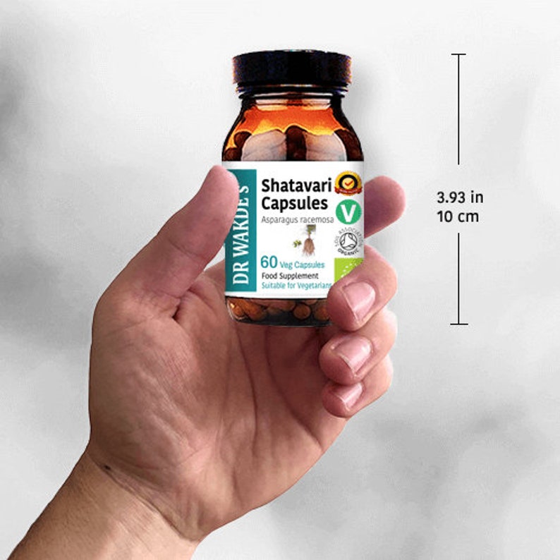 May include: A brown glass bottle with a white label that reads "Shatavari Capsules Asparagus racemosa 60 Veg Capsules Food Supplement Suitable for Vegetarians". The bottle is 10 cm tall.