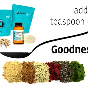 May include: A spoonful of various powders, including turmeric, cacao, hemp seeds, red raspberry, chia seeds, and matcha powder. The text "add a teaspoon of Goodness" is written above the spoon.