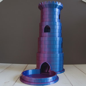 May include: A three-tiered cylindrical dice tower featuring a brick-patterned texture and a gradient color scheme that shifts between metallic blue and purple. The structure includes a circular base tray and arched openings on each level.