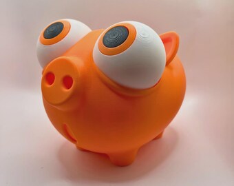 May include: An orange piggy bank with large, cartoonish eyes. The eyes are white with black and orange details. The pig has a round body, small ears, and a snout with two nostrils. The bank is a fun and whimsical design.