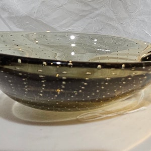 Carl Erickson art glass ashtray. Smoky glass with controlled bubbles. Sits asymmetric and has an applied tongue. MCM in appearance.