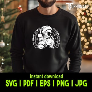 May include: A black sweatshirt with a white graphic of Santa Claus wearing sunglasses and a Santa hat. The graphic says "You should see the size of my sack".