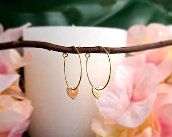 Subtle, gold-plated hoop earrings with heart pendant
