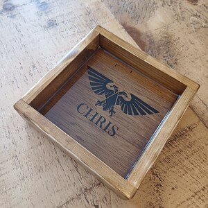 May include: A wooden tray with a clear acrylic insert. The insert features a black eagle design and the name "CHRIS" in black lettering.