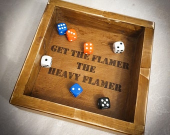 May include: A wooden box with the words "Get the Flamer The Heavy Flamer" engraved on the inside. There are six dice inside the box, two blue, one orange, and three white.