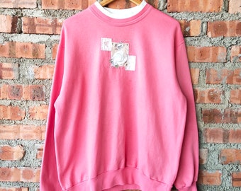 peach colored sweatshirt