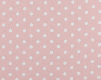 Könnte beinhalten: Ein rosa Stoff mit weißen Punkten.