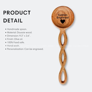 May include: A wooden spoon with a twisted handle and a rounded bowl. The bowl is engraved with the text "Custom Engraved" and a heart. The spoon is 9.3 inches long and 2.6 inches wide.