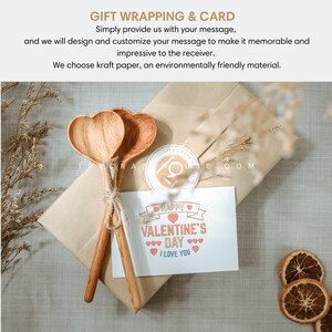 May include: A brown paper gift box with two wooden heart-shaped spoons tied together with twine. The box has a card on top that says "Happy Valentine's Day I Love You" with a red heart.
