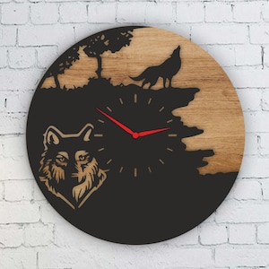 May include: A round wooden clock with a wolf theme. The clock face features a howling wolf silhouette, a wolf head, and a tree. The clock hands are red. The clock is mounted on a white brick wall.