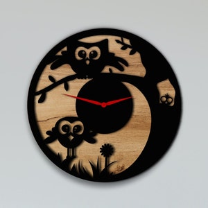 May include: A wooden clock with a black silhouette of two owls and a tree branch. The clock face is black with red hands.