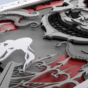 May include: A 3D papercraft design featuring a white silhouette of a mermaid with flowing hair, a black and gray octopus with tentacles, and a red and gray anchor with a detailed design.