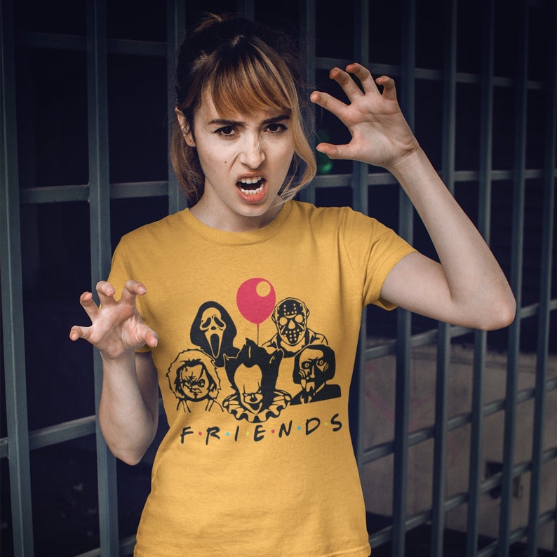 May include: A yellow t-shirt with a graphic of horror movie characters, including Pennywise, Freddy Krueger, Jason Voorhees, and Ghostface. The text "FRIENDS" is printed below the graphic.