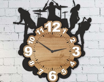 May include: A black silhouette of a band playing drums and guitars is used as the clock hands and numbers on a wooden clock face. The clock face is surrounded by a black silhouette of a band playing drums and guitars.