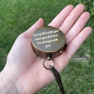 May include: A brass compass with a chain, engraved with the words "Carry this with you when you feel lost. I'm always with you."