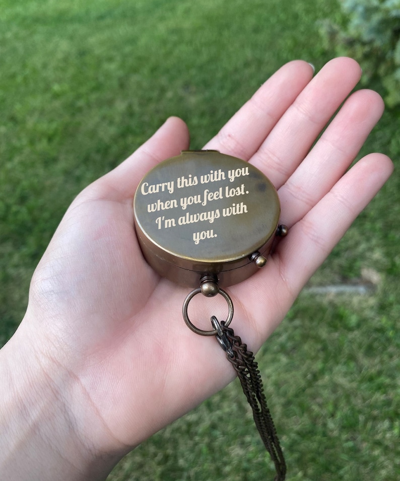 May include: A brass compass with a chain, engraved with the words "Carry this with you when you feel lost. I'm always with you."