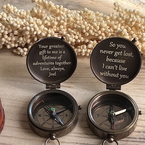 May include: Two antique brass compasses with engraved messages. The top compass reads "Your greatest gift to me is a lifetime of adventures together. Love, always, Joel". The bottom compass reads "So you never get lost, because I can't live without you".
