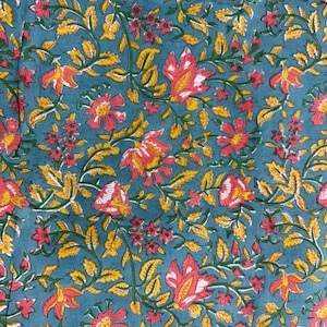 May include: Close-up of a teal fabric with a floral pattern. The design features red and yellow flowers with green leaves and vines. The flowers have white accents, and the leaves are a bright yellow.