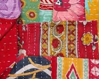 May include: A patchwork quilt made of various colorful fabrics with floral and geometric patterns. The quilt is made of different shades of red, yellow, green, blue, and pink.