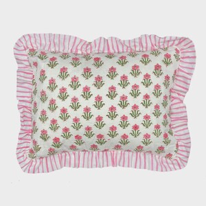May include: A rectangular throw pillow featuring a white base with a repeating pattern of small pink flowers and green stems. The pillow is finished with a ruffled border decorated in a pink and white vertical stripe pattern on all four sides.