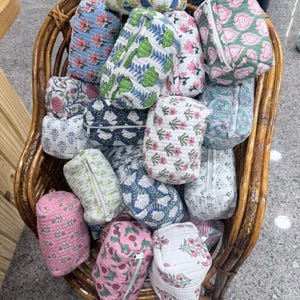 May include: A set of three ceramic mugs with a speckled, matte finish. The mugs are in shades of cream, light gray, and dark gray. Each mug has a simple, minimalist design, perfect for coffee or tea.