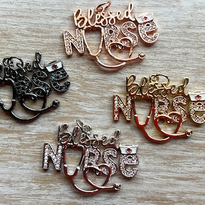 May include: Four gold-tone charms with rhinestones spelling "Blessed Nurse" with a stethoscope and a red cross.