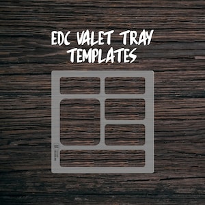 May include: A white template for a valet tray with six rectangular compartments. The template is on a dark brown wooden background. The text "EDC VALET TRAY TEMPLATES" is above the template.