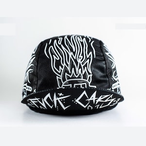 May include: Black cycling cap with a white graphic design of flames and the text "CYCLE CARS".