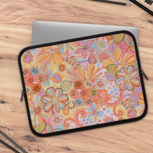 May include: A laptop sleeve with a colorful floral pattern in shades of orange, pink, yellow, and blue. The sleeve has a zipper closure and a black border.