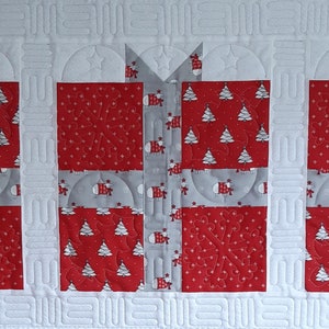 May include: Three red and white gift boxes with a gray ribbon and bow. The boxes are decorated with a white snowflake pattern and a white Christmas tree pattern.