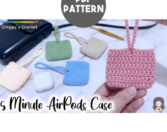 May include: A collection of small, square, crocheted pouches in pastel colors including pink, blue, green, beige, and cream, each with a matching loop handle. The image features the text PDF PATTERN, Creggy's Crochet, and 5 Minute AirPods Case.