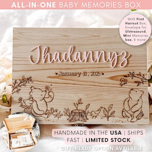 May include: A wooden baby memories box with the name "Thadannyz" in pink script. The box features engraved illustrations of Winnie the Pooh characters and the date "January 11, 2025". Includes a small open box with contents.