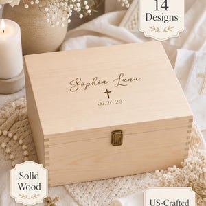 May include: A rectangular light-colored wooden keepsake box with a metal latch. The lid is engraved with the name Sophia Luna, a cross symbol, and the date 07.26.25. Text overlays on the image state 14 Designs, Solid Wood, and US-Crafted.