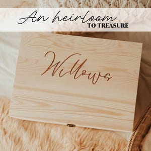 May include: A rectangular light-colored wooden box with a hinged lid and a metal latch. The lid features the engraved name Willow in a cursive script. Above the box, the text An heirloom TO TREASURE is displayed in a black font.