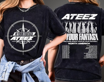 May include: Black t-shirt featuring the text "IN YOUR FANTASY ATEEZ" in white, with a compass rose design. The back of the shirt displays "ATEEZ YOUR FANTASY 2025 WORLD TOUR NORTH AMERICA" and a list of tour dates and locations.