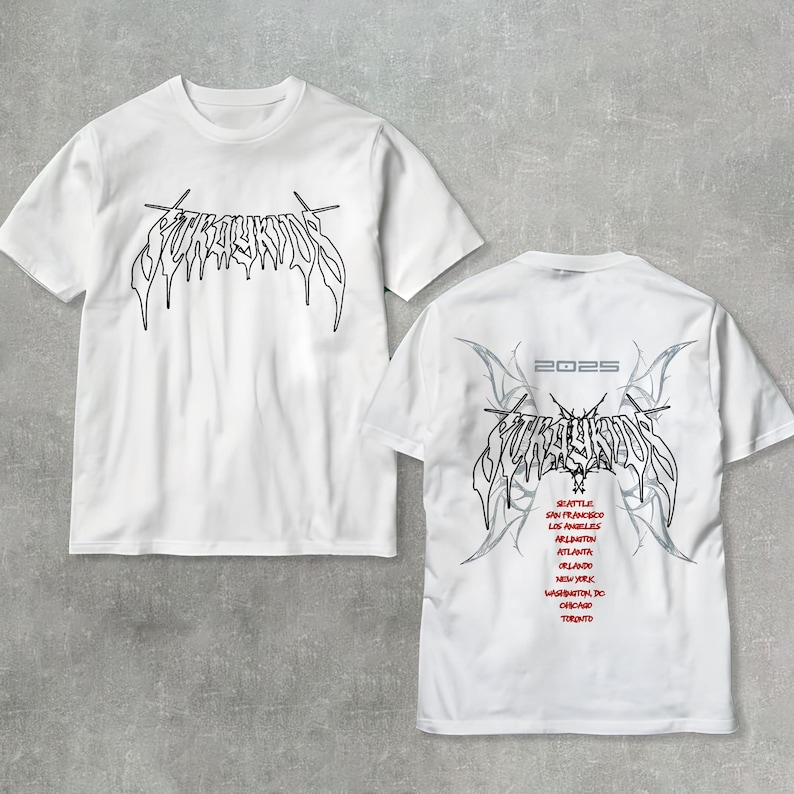 May include: Two white t-shirts with a black graphic print of the word "FURY" in a stylized font. The back of one shirt has the word "FURY" in the same font with a gray design and the text "2023" above it. The shirt also lists a tour schedule with cities including Seattle, San Francisco, Los Angeles, Atlanta, Orlando, New York, Washington DC, Chicago, and Toronto.