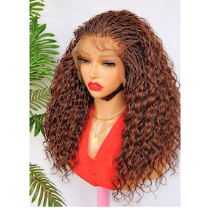 May include: A brown braided wig with long, curly hair. The wig features a lace front and is styled on a mannequin head. The mannequin is wearing a red top and gold necklace. The wig is a rich shade of brown.