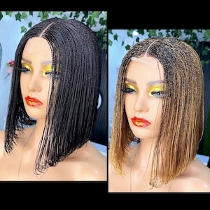 May include: Two wigs are displayed, one black and one with a brown ombre. Both wigs are styled in a short, bob-like cut with micro braids. The wigs are on mannequin heads, showcasing the hairline and overall style.