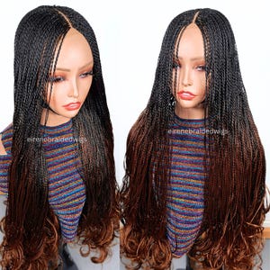 May include: A braided wig with a black to brown ombre effect. The wig is styled with small, individual braids that transition from black at the roots to brown at the ends. The wig is displayed on a mannequin head.