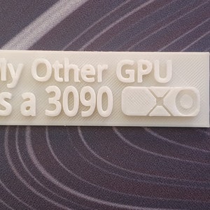 May include: White 3D printed sign that reads "My Other GPU Is a 3090" with a stylised "X" logo.