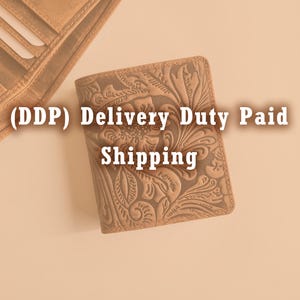 May include: A tan leather wallet with an embossed floral design. The wallet is closed and rectangular, with a detailed pattern of flowers and leaves. The text "(DDP) Delivery Duty Paid Shipping" is visible.