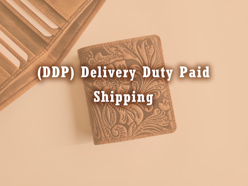 May include: A tan leather wallet with an embossed floral design. The wallet is closed and rectangular, with a detailed pattern of flowers and leaves. The text "(DDP) Delivery Duty Paid Shipping" is visible.