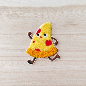 May include: A yellow and red embroidered pizza slice with a smiling face and brown legs, running. The pizza slice has a white outline.